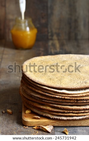 Baked layers for a honey cake on a wooden table.
