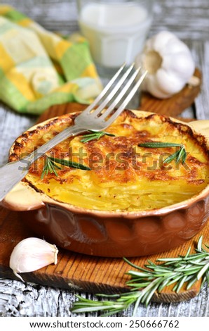Potato slices baked in milk with cheese,garlic  and herb in rustic style.