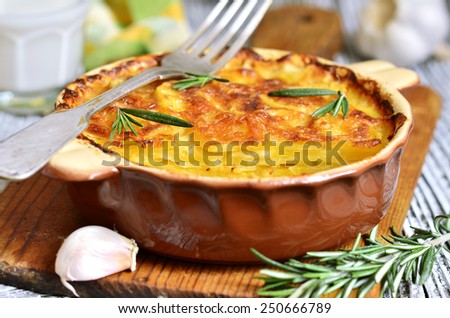 Potato slices baked in milk with cheese,garlic and herb in rustic style.