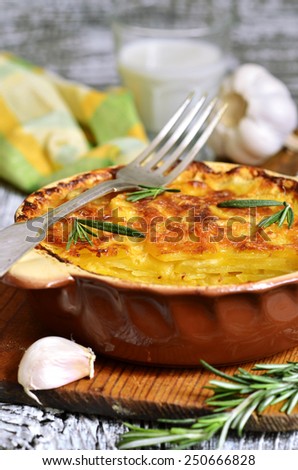 Potato slices baked in milk with cheese,garlic  and herb in rustic style.