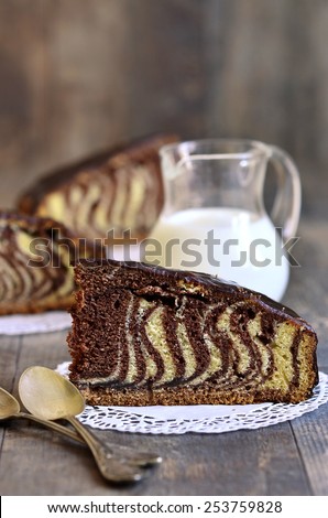 Piece of \'\'Zebra\'\' cake with chocolate glaze.