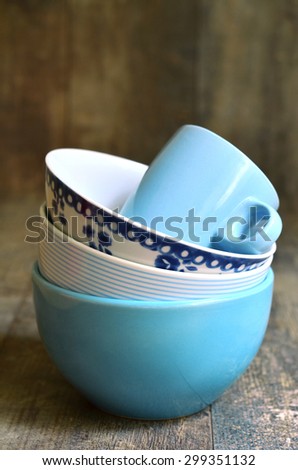 Tableware set in blue colours on wooden table.