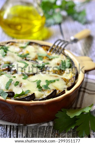 Musaka - traditional dish of greek cuisine on rustic background.