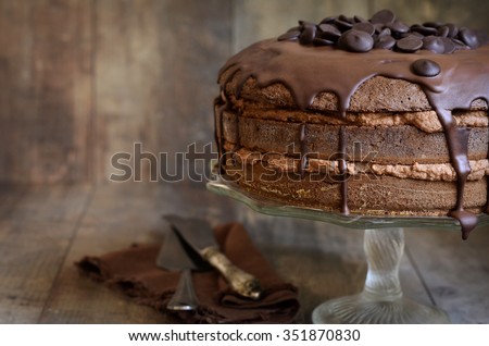 Chocolate cake with mascarpone on rustic background.