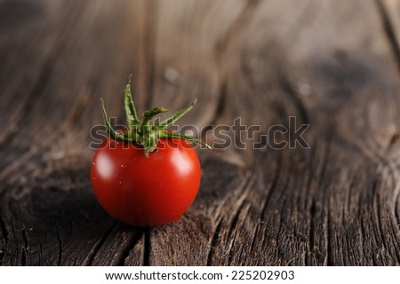 Tomatoes on brown textured wood