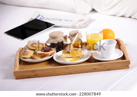 Breakfast food on the bed inside a bedroom