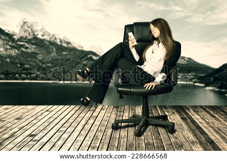 Lazy woman feet up on chair checking the phone.