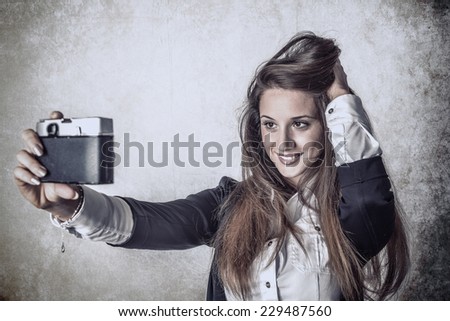 Woman taking self-portrait from vintage  film camera