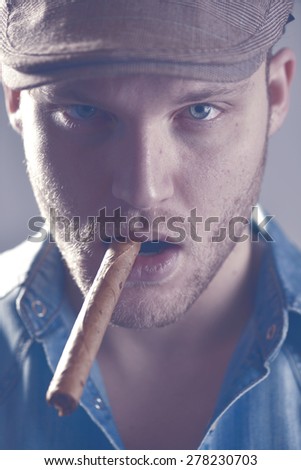 Casual young man  with cigar