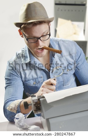 Agent with an old type writer and cigar