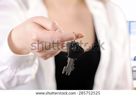 businesswoman ,real estate agent, with house keys in hand