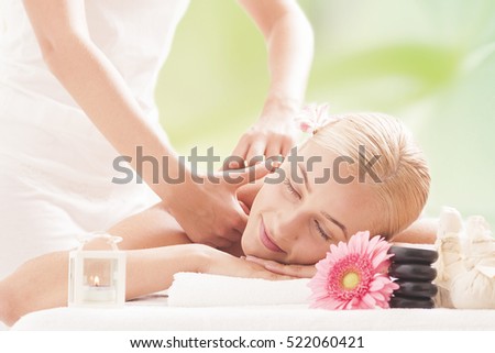 Blonde woman relaxing in massage at the spa