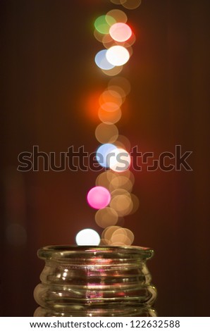 Glass jar with magical bokeh dots popping out.