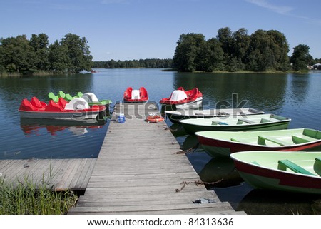 Pedalos and boats for sailing in the lake Galve around historical landmark Trakai castle