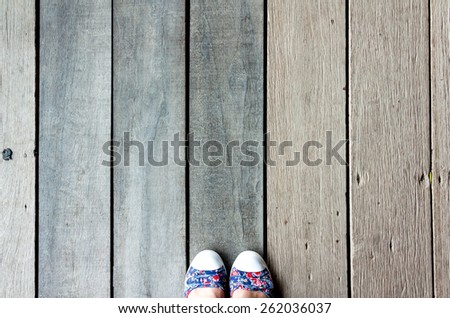 Top view of wood floor and human feet