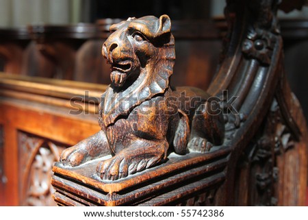 Carved oak lion on arm of pew, Bath Abbey, England