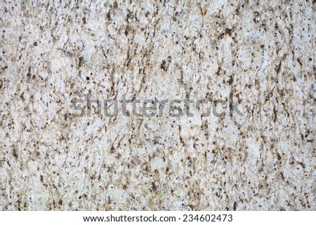 Texture of Polished Granite Surface With Black and Brown Dots on Substrate of Beige Color.