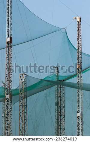 Steel Pillars Holding A Giant Net To Intercept Golf Balls. In A Golf Practicing Range.