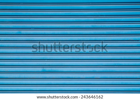 Background of Blue Rolling Shutter Door. Aged And Weathered