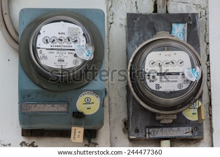 Kaohsiung, Taiwan, Jul,26,2014: Vintage Analog Electricity Meters on An Old Wall. Both Are Manufactured During The 1980s. Old Buildings in Taiwan Still Use This Kind of Meters.