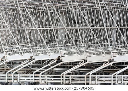 Close Up of The Metal Mesh of Shopping Carts Lined Up in A Row.