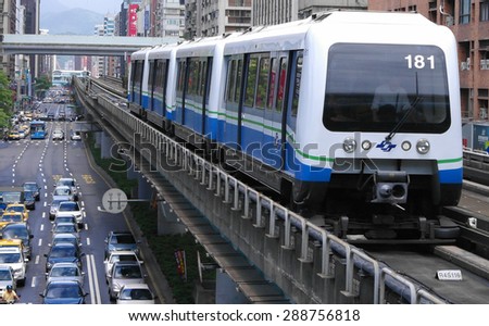 Taipei, Taiwan, Aug, 28, 2011: Taipei Metro Wenhu  Line (Known as The Muzha Line Before Oct, 8, 2009). The Train Runs on Elevated Rails While Other Cars Jammed on The Roads.