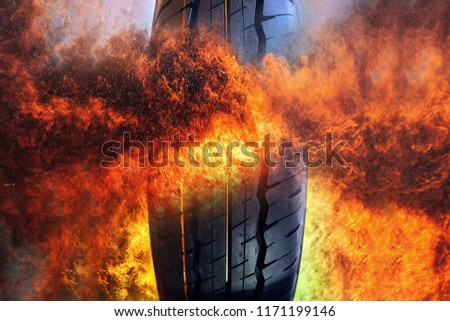 Close-up photo of Car tire on frame of fire  background . Rubber product .