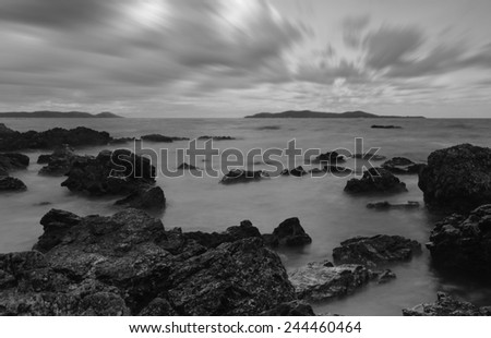 Evening light sunset sea waves splashing rocks black and white tone.
