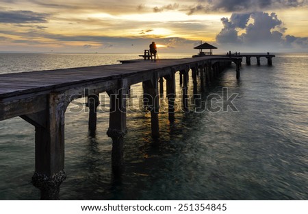 Photographers take pictures on the bridge at  wood bridge at seaside east of Thailand.