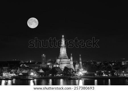 Wat Arun Twilight reflection pool in Bangkok Thailand with Full moon black and white tone.