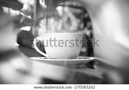 hot coffee love frame white book on wood coffee table coasters soft focus black and white tone.