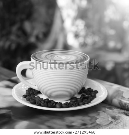hot coffee, smoke on surface coffee mugs  ,cup of coffee on magazine black and white tone.