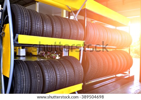 Car tires at warehouse with sun rays.