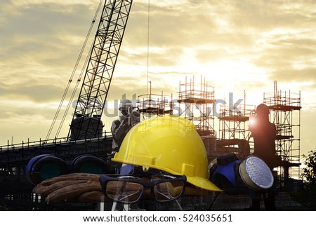 Set of safety work wear on  construction background ,Work safety at construction site concept .