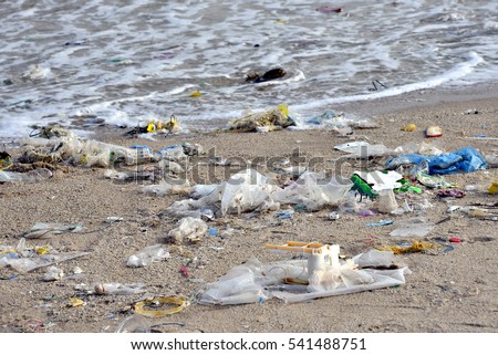 Beach pollution. Plastic bottles and other trash on sea beach