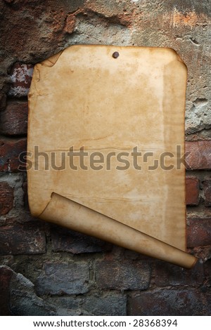 Old sheet of paper, nailed to a wooden wall