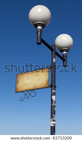 Grunge street lamp with a sign for advertising