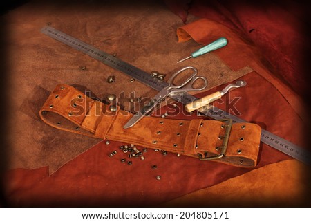 Suede leather belt on background in studio