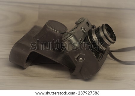 Old retro camera on vintage wooden boards abstract background
