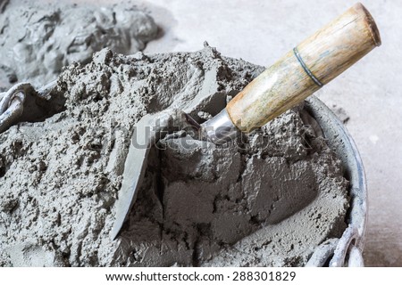 Pick up a trowel and cement mix concrete is compacted sand. Waiting to be mixed with cement
