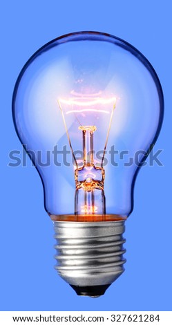 Glowing yellow light bulb, realistic photo image of a turned on tungsten light bulb with a blue background and a clipping path