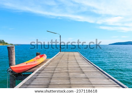 Kayak on Wooden Pier with Blue sea and sky at Ko lam ya National park, Thailand