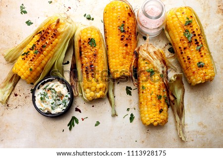 Grilled sweet corn with smoked paprika,  salt and cilantro.Summer vegan dinner or snack