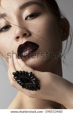 Beauty Vogue Style Fashion Chinese Model Girl with Dark lips and Big Black Ring. Fashion Trendy Make-up. Desire