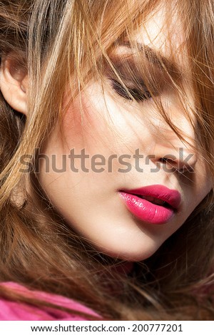 Beautiful young model with pink lips. Trendy fashion look
