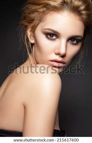 Beautiful woman with evening make-up and perfect skin . Smoky eyes. Fashion photo
