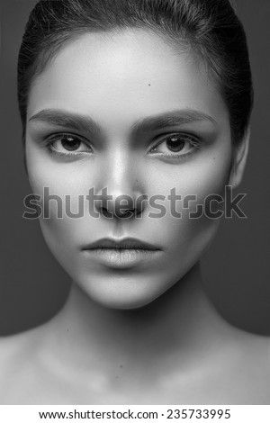 Beautiful face of young adult caucasian woman with clean fresh skin and natural make-up. Black and white photo