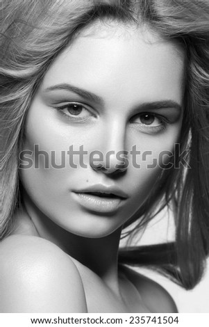 Black and white photo of beautiful face of young blond woman with clean fresh skin and natural make-up