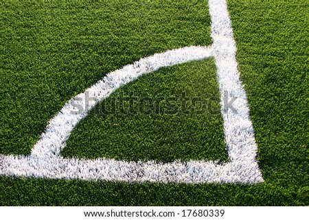 A soccer field\'s corner line where kicks are taken
