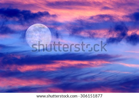 Moon clouds skies is a vibrant surreal fantasy like cloudscape with the ethereal heavenly full moon rising among the vibrant cloudscape.